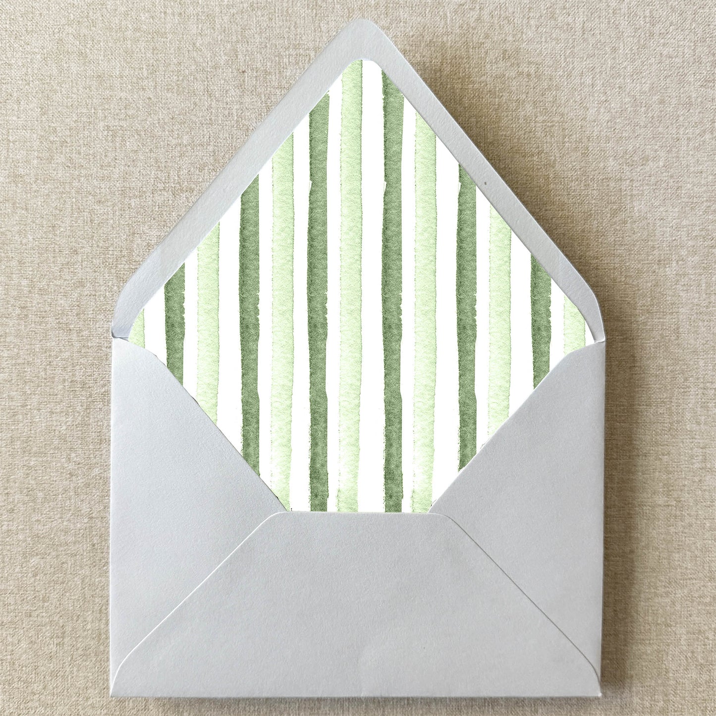 Sage Green Stripe Envelope Liner on linen background