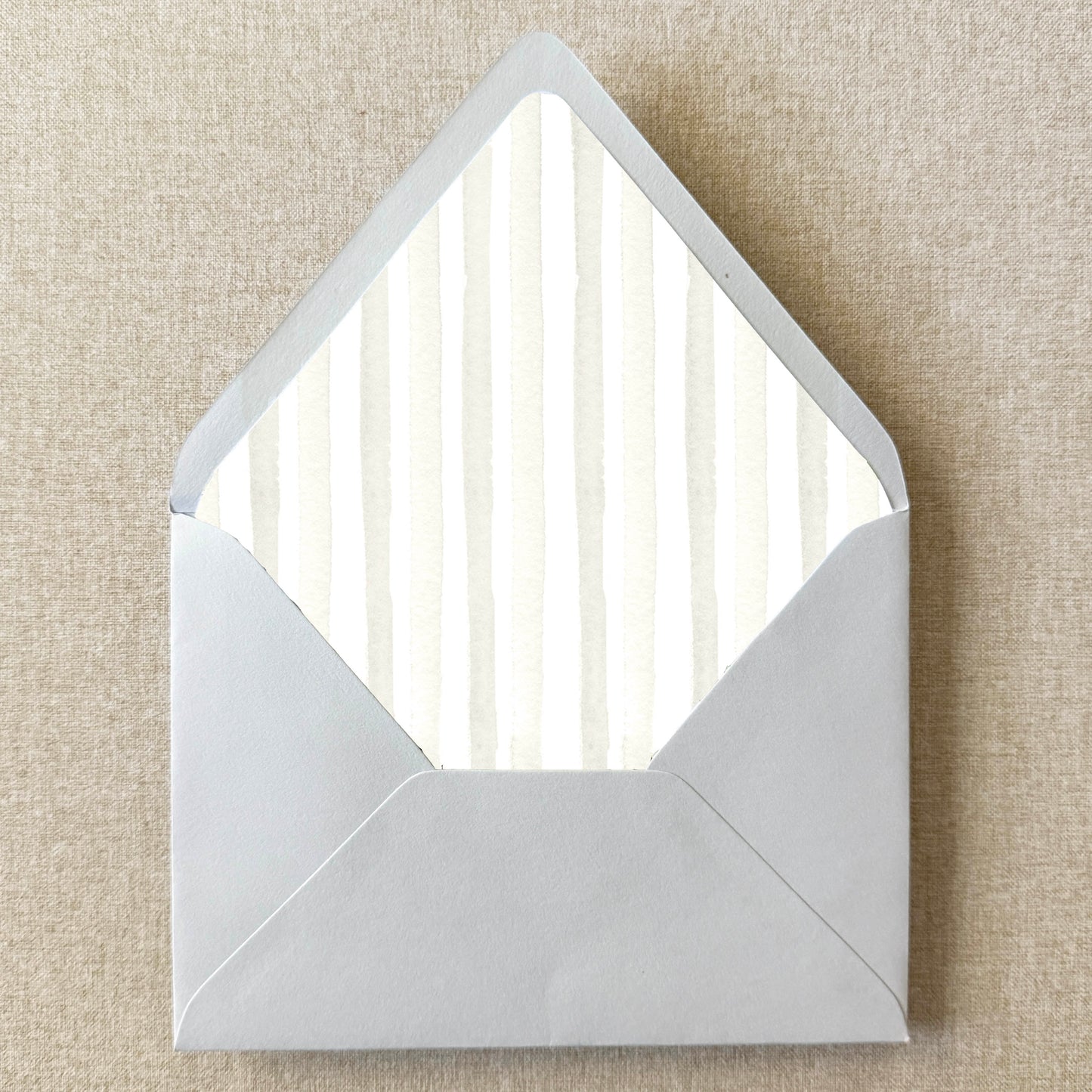 Ivory Cream Stripe Envelope Liner on linen background