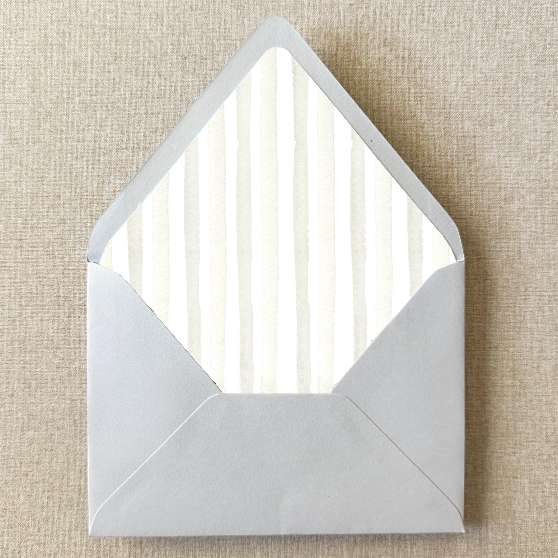 Ivory Cream Stripe Envelope Liner on linen background