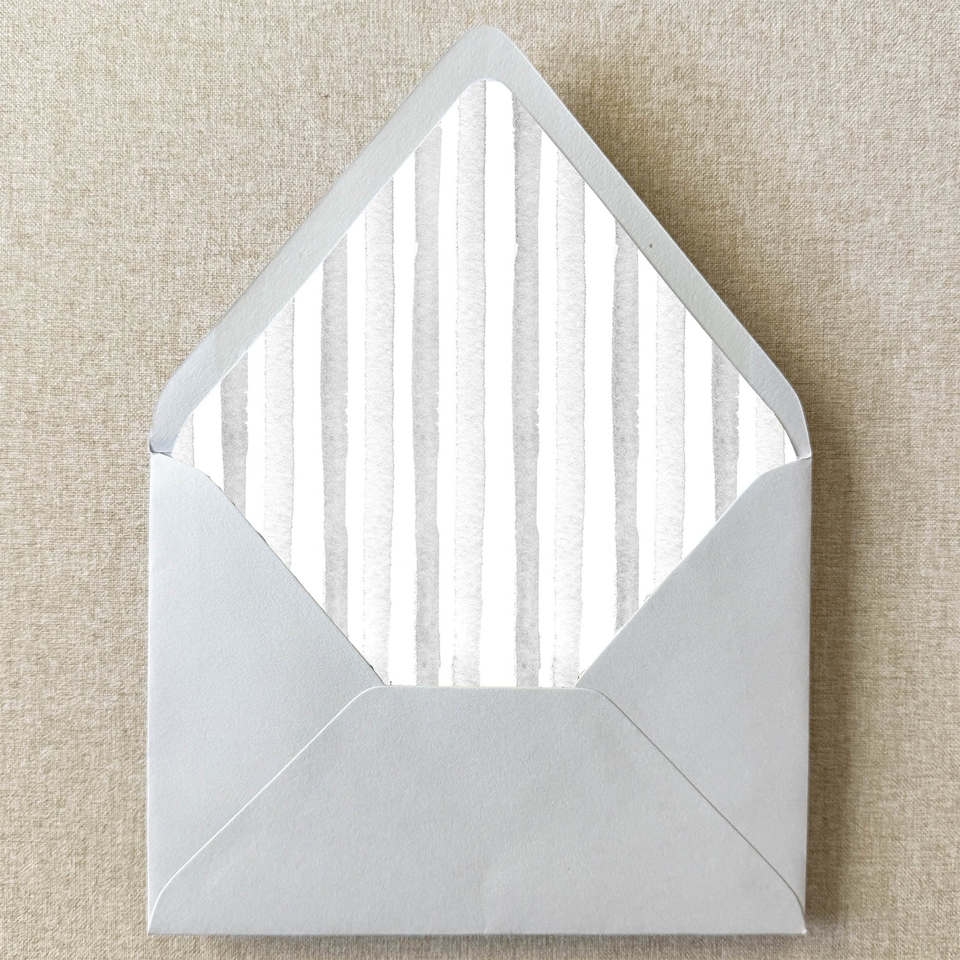 Grey Stripe Envelope Liner on linen background