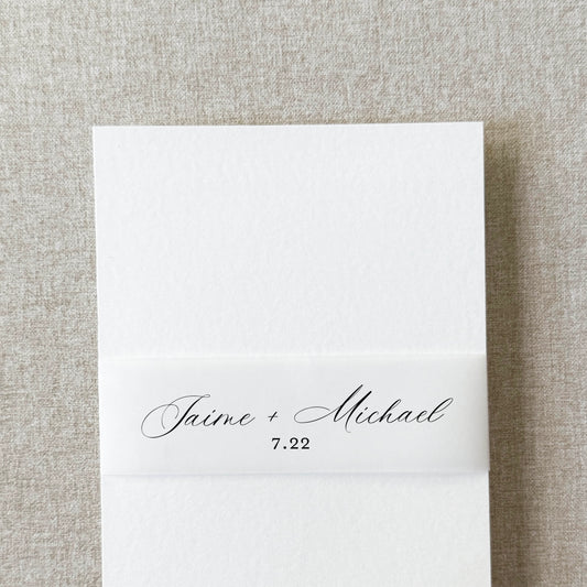 Custom wedding belly band in modern script wrapped around an invitation suite