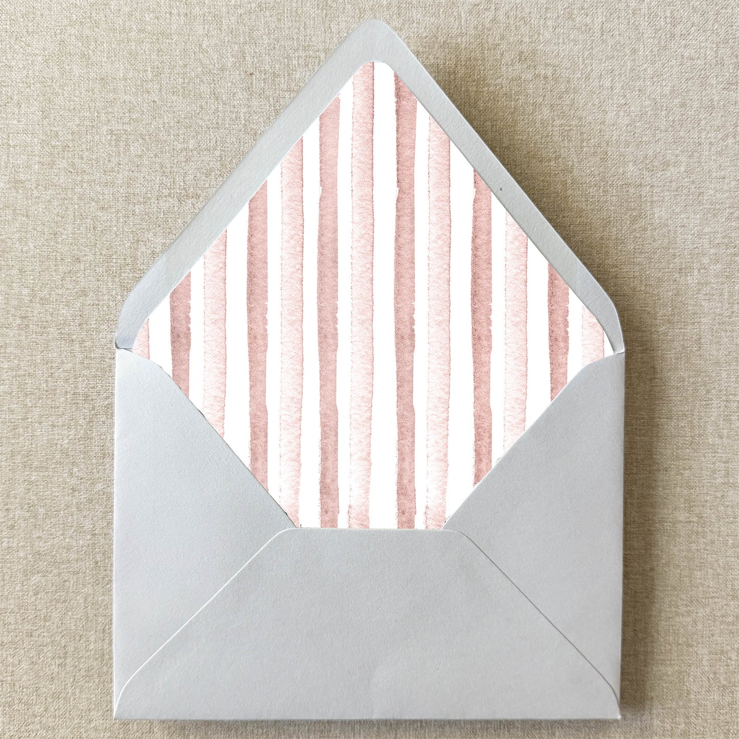 Blush Pink Stripe Envelope Liner on linen background