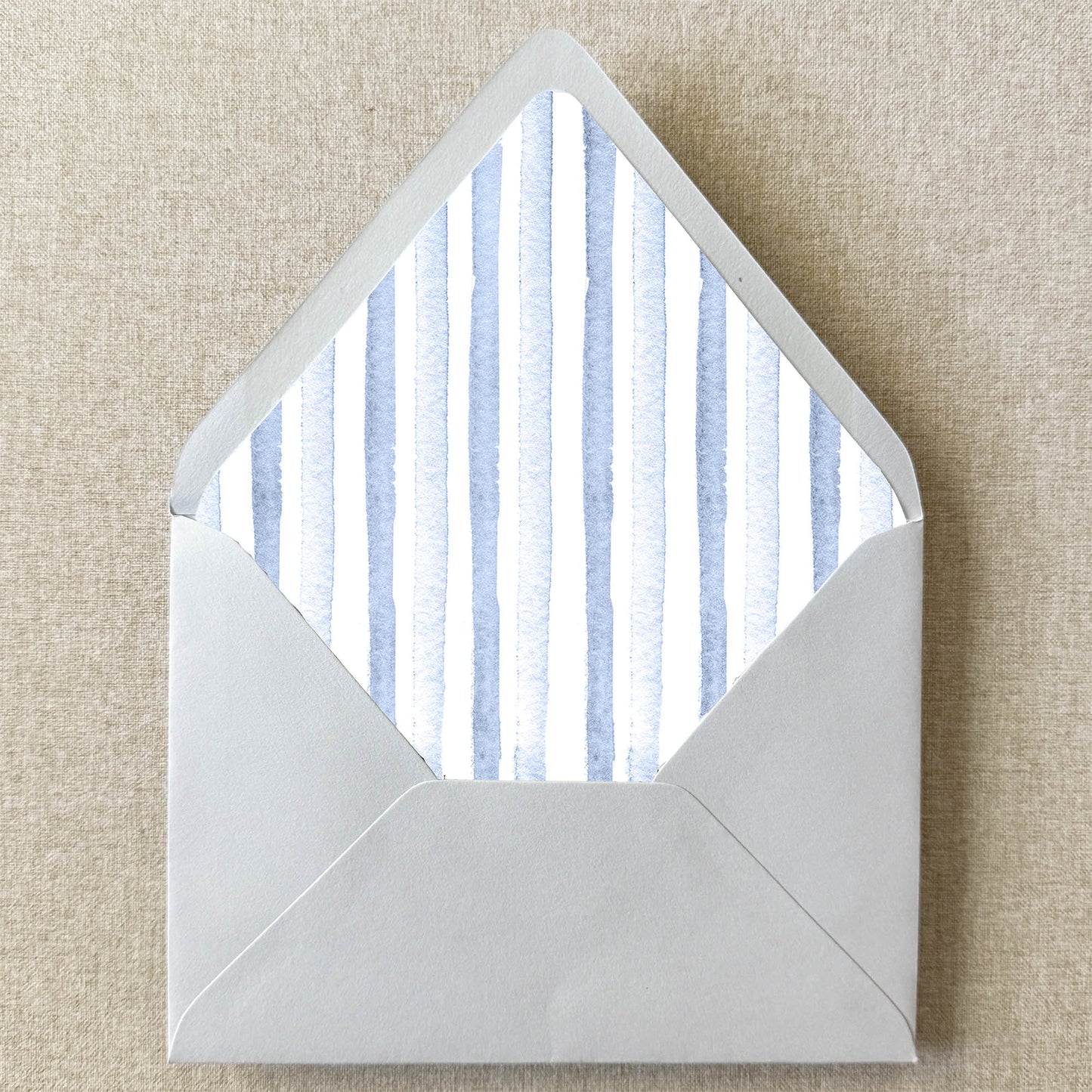 Dusty Blue Stripe Envelope Liner on linen background