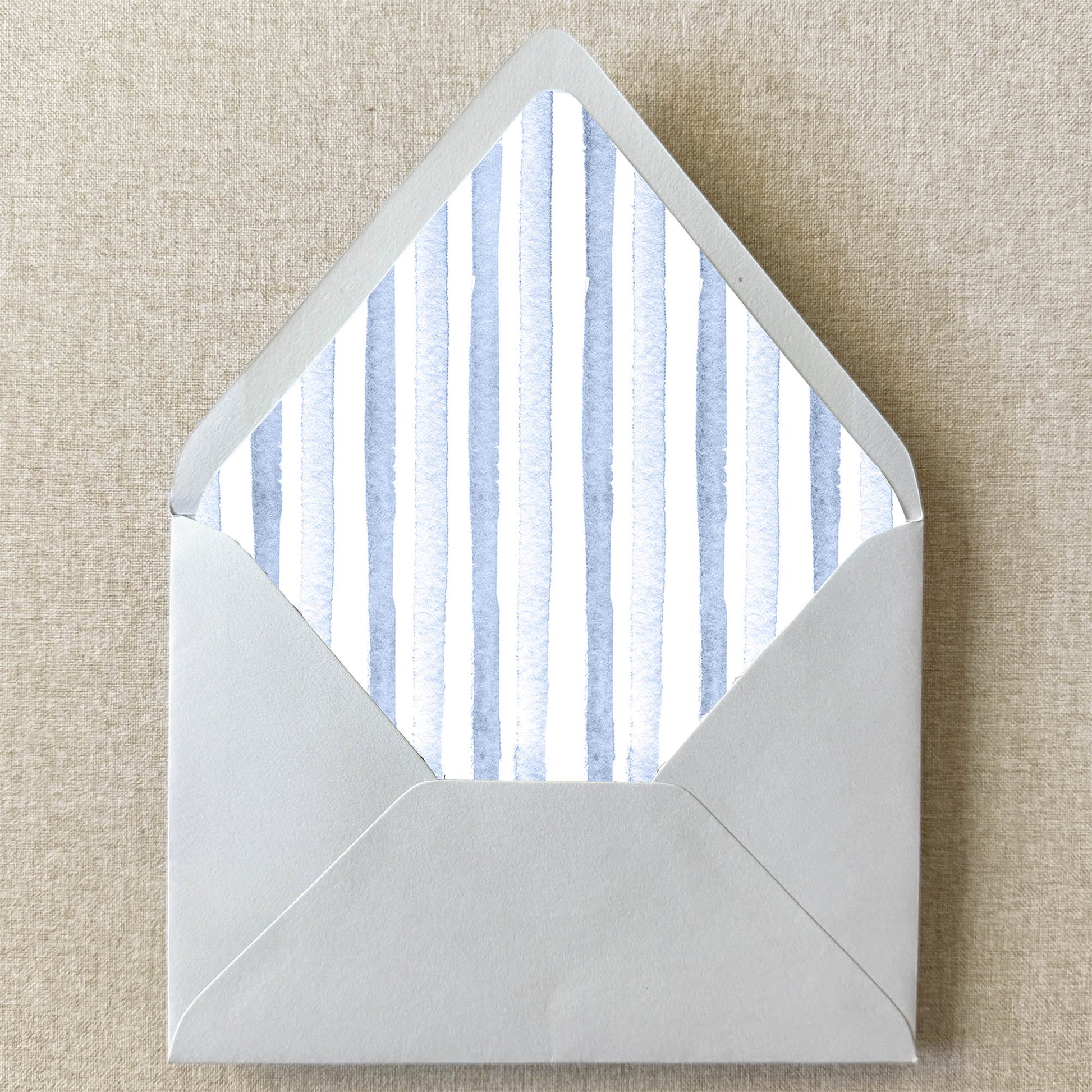 Dusty Blue Stripe Envelope Liner on linen background